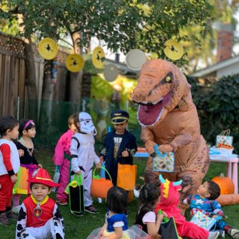 Mr. Dinosaur-handing-out-goodie-bags-at-the-Halloween-party